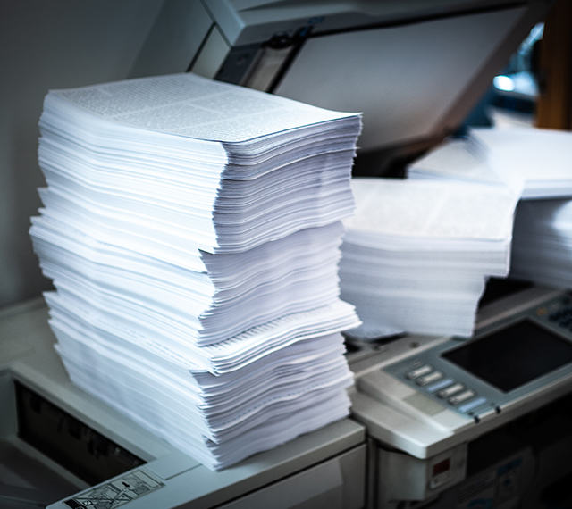 large stack of legal documents on a scanner.